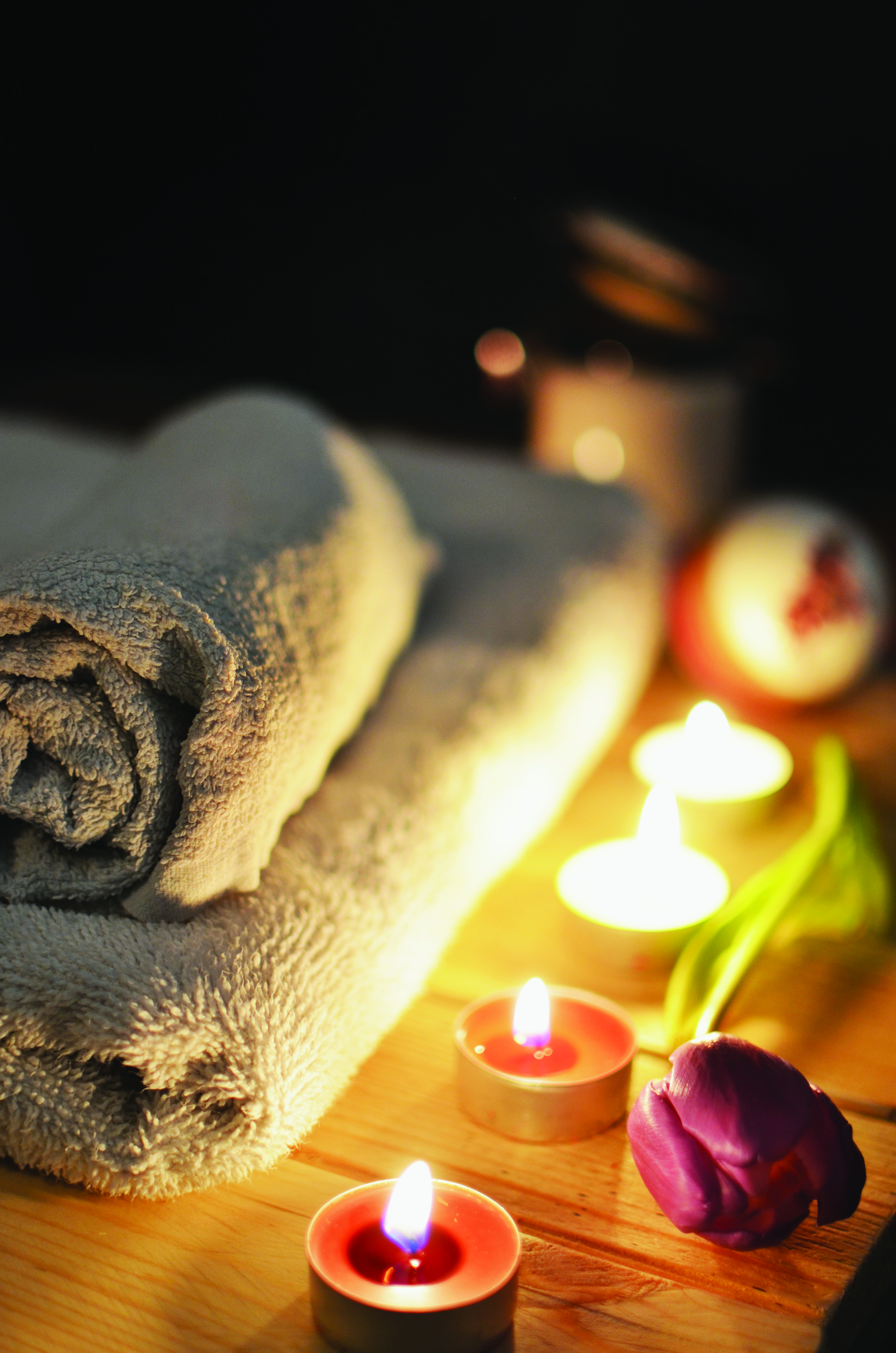 Image of Towel, Flower and Lit Candles for Spa Treatments at Badwell Ash Holiday Lodges